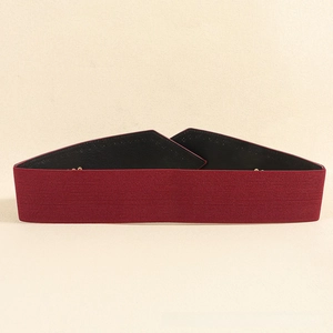 Detail view of burgundy wide elastic belt with premium woven texture and secure golden snap button