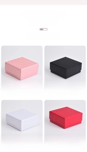 Diamond pattern jewelry boxes in pink, black, white, and red with a flip lid design