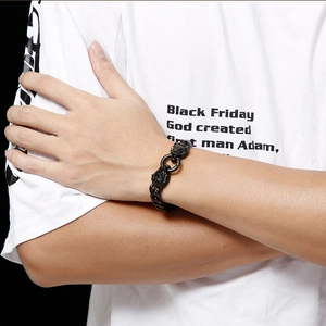 Men's bold black lion head cuban link bracelet in stainless steel on wrist