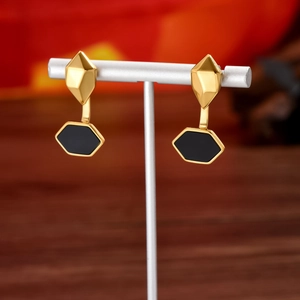 French retro gold geometric hexagonal earrings with black enamel inlay on silver stand