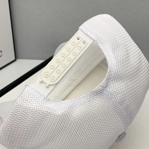 Detail of white mesh baseball cap featuring breathable fabric and adjustable snapback closure