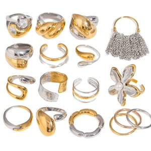 Minimalist gold and silver two-tone rings set featuring pearls and polished metal finish