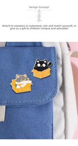 Close-up of cute cartoon cat enamel pins pinned on a blue canvas bag accessory