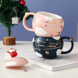 Christmas ceramic mugs in pink and navy blue with gold cloud patterns and Santa lid