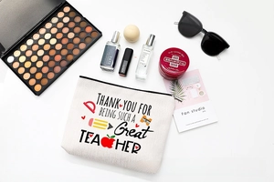 Flat lay of canvas teacher gift makeup bag with school stationery illustrations and accessories
