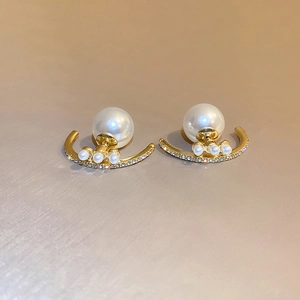 Elegant curved rhinestone and faux pearl stud earrings in gold finish for women