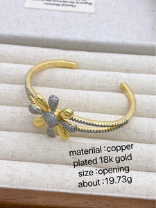 Macro view of 18k gold plated copper daisy bracelet with cubic zirconia detailing
