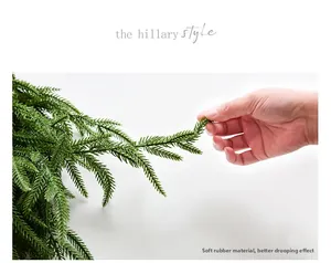Close-up of flexible soft glue Norfolk pine branch with a natural hanging effect