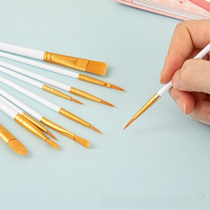 Detail of 10-piece nylon paint brush set with white handles and various tips for watercolor