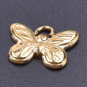Macro detail of a 18k gold-plated butterfly pendant with intricate wing textures