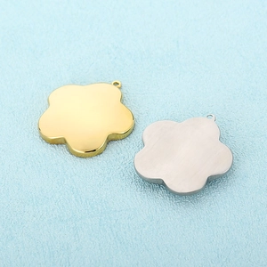 Detailed view of flower-shaped stainless steel pendants in gold and silver polished finishes