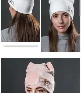 Detail of velvet winter hat with rhinestone bow and metallic flower embellishments