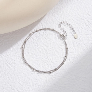 Detail of double-layer S925 silver chain with small beads and lobster clasp closure