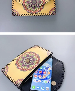 Detailed macro view showing the ethnic mandala pattern and hand-stitched edges of the bag