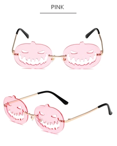Detailed view of pink pumpkin-shaped Halloween sunglasses with golden metal frames