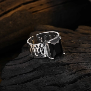 Vintage adjustable strap ring with black zircon stone on rustic dark wood surface