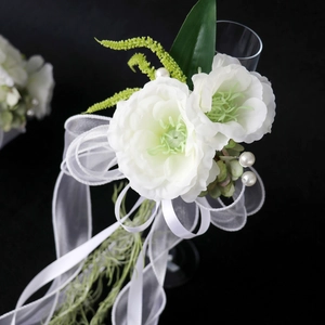 Elegant white wedding champagne glass flower decoration with artificial pearls and green leaves