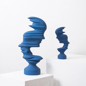 Modern abstract blue face sculpture set for minimalist home decor on a white pedestal