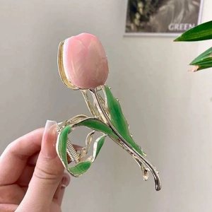 Detail view of pink tulip hair claw clip with gold alloy base and enamel petals