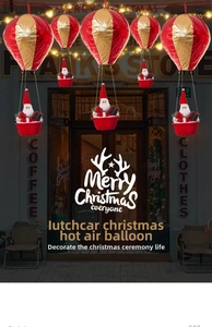 Detail of hanging Santa Claus hot air balloon decoration in red and gold festive theme