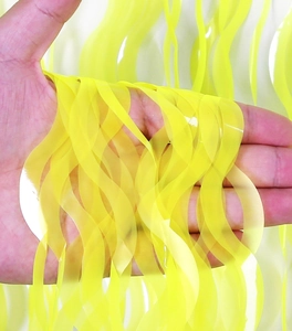 Close-up of yellow wavy fringe curtain for festive party decoration and table styling
