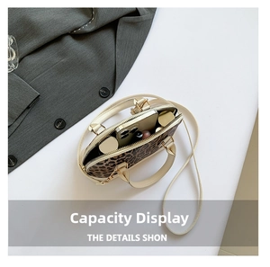 Top view of leopard print mini handbag showing interior capacity with phone and cosmetics