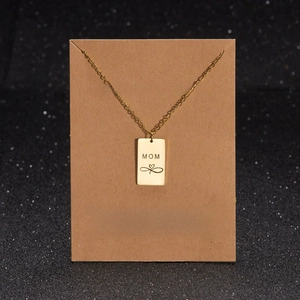 Detail of gold Mama pendant with heart infinity symbol on gift message display card