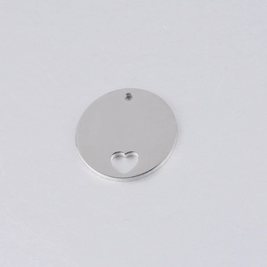 Close-up of a 20mm round stainless steel pendant with a hollow heart shape cutout
