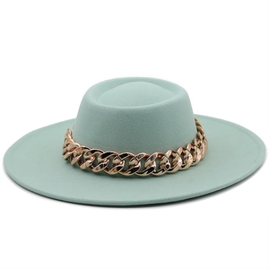 Detailed view of mint green flat top wool felt hat with thick gold chain decoration