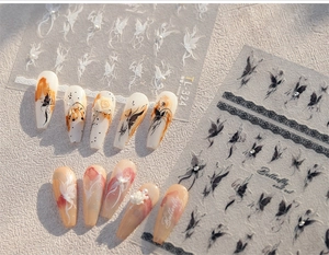 Detail of 3D butterfly nail stickers with pearls on soft pink gradient fake nails