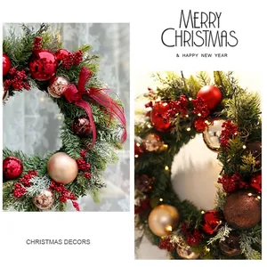 Christmas wreath with red berries, decorative balls and warm LED lights for wall hanging