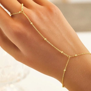 Detailed close-up of a gold S925 sterling silver finger bracelet with small beads decor