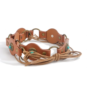 Detail of vintage belt with turquoise inlay, brown leather patches and braided hemp rope