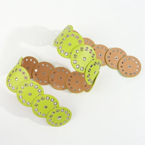 Detailed shot of lime green and khaki leather discs with silver metal eyelets belt