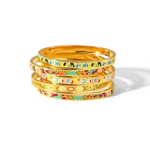 Stack of 18K gold-plated stainless steel bangles with colorful enamel floral patterns