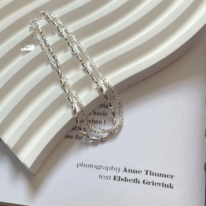 Detail view of silver double-layer beaded chain and twisted link texture necklace