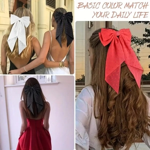 Close-up of large polka dot bow hair clips in white, black and red on various hairstyles