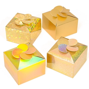 Detail of four golden gift boxes featuring diverse laser holographic and matte textures