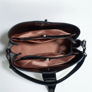 Top view of large capacity bucket bag showing multi-compartment interior and satin lining