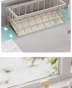 Close-up of cream-colored kitchen sink organizer rack with drainage tray and wide mesh