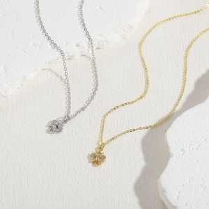 Macro shot of silver and gold elephant pendants featuring fine white cubic zirconia inlay