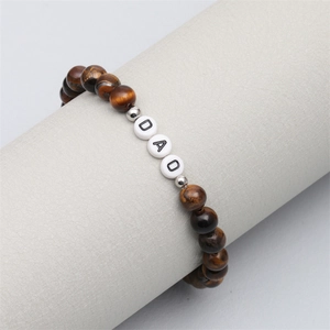 Detail view of tiger eye bead bracelet with DAD letter beads on display stand