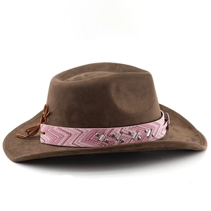 Detail of brown suede cowboy hat featuring a pink geometric band with metal studs and sequins