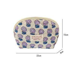 Detail view of beige quilted floral makeup bag with 22x15x8cm dimension labels