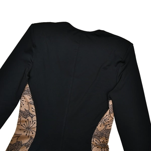 Detail view of black long sleeve jumpsuit with leopard print side panels and stitching