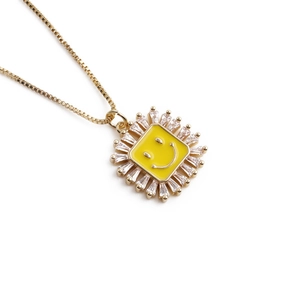 Gold box chain necklace featuring a square zircon pendant with a yellow smiley face