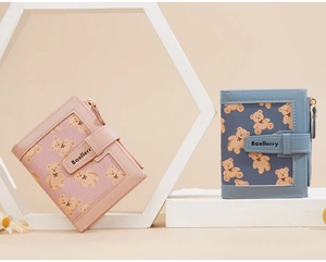 Detail view of pink and blue folding wallets with cute bear prints and zipper closure