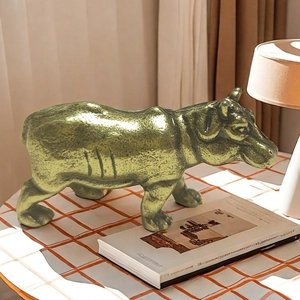 Detailed view of a solid brass hippo tea pet statue with a textured bronze finish