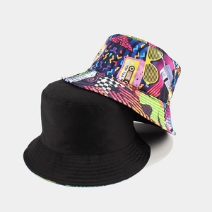 Reversible bucket hat for men and women featuring vintage 80s tape print and plain black side