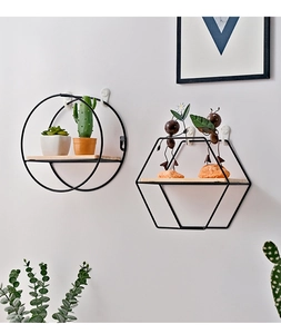 Detail of Nordic round and hexagonal wall shelves with black iron frames and wooden bases